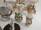 many different pieces of porcelain sitting on a table