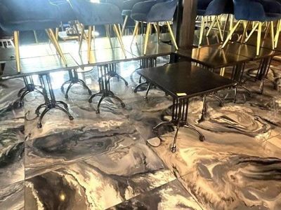 many chairs and tables in a room with marble flooring