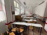 many empty desks and chairs in this classroom