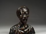 a bronze bust of a man with a turban on his head