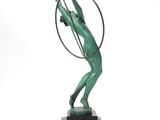 statue of a woman holding a hoop in her hands