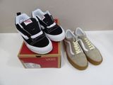 pair of black and white vans sneakers sitting on top of a box