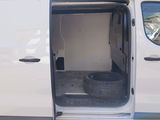 a white van with its door open and a tire in the back