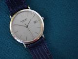 a watch that is sitting on a blue cloth