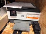 a printer sitting on top of a table with a printer on it