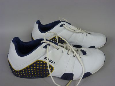 white and blue tennis shoes with yellow dots on the sole