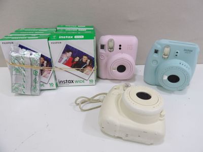 three cameras sitting next to each other on a table