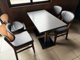 a table and chairs in a restaurant with a large window