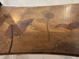a wooden chair with a painting on the back of it