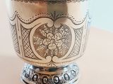 someone is taking a picture of a silver bowl on a table