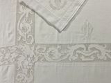 a white table cloth with a cross design on it