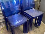 three blue plastic chairs sitting next to each other in a room