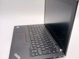 a laptop with a black keyboard sitting on a white surface