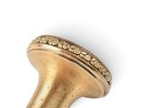 an image of a gold colored object on a white surface