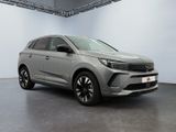 a grey suv parked in a garage with a white wall