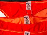 three pairs of orange and black underwear with labels on them
