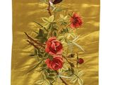 une soie jaune ornée de fleurs rouges et d'oiseaux, accrochée au mur