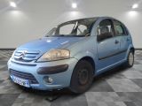 a small blue car parked in a room with checkered floor