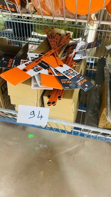 a shopping cart full of orange balloons in a store