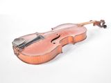 a violin that is sitting on a white surface