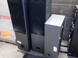 three speakers sitting on a pallet in front of a wall