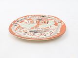 a plate with a picture of a city on it