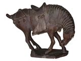 statue of a horse with a saddle on it ' s back on a white background