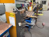 a picture of a machine that is working on a piece of metal
