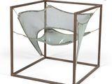 a metal frame with a chair inside of it on a white background
