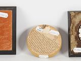 three different types of framed objects are displayed on a white surface