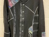 a close up of a jacket on a hanger on a wall