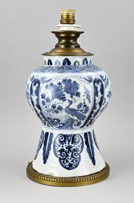 an image of a blue and white vase with a brass base