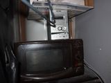 a microwave sitting on top of a stack of appliances