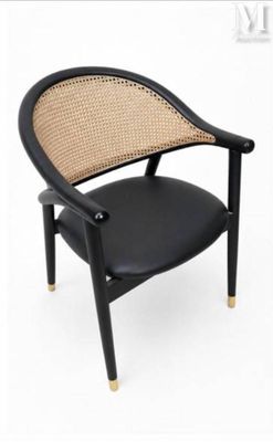 the chair is made of black leather and has a rattan back