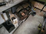 a pile of boxes and tools on a shelf