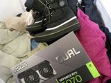 a box with a pair of shoes on top of a pile of clothes