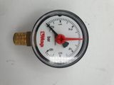 a close up of a pressure gauge on a white surface