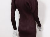 the back view of a mannequin dress with long sleeves and a high neckline