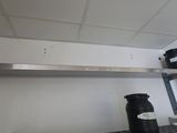 a metal shelf that has some jars on it
