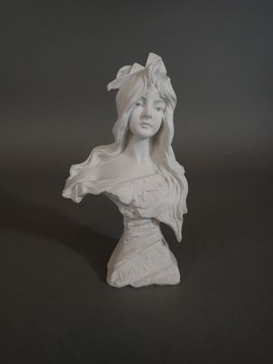 statue of a woman with long hair wearing a white dress