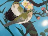 a picture of a plate with a bird and flowers on it