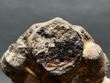 a close up of a statue of a person holding a rock