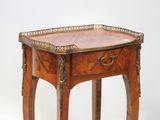 a small wooden table with a drawer on top of it