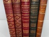 a group of five books sitting next to each other on a table