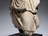 a marble head of a woman with a veil on her head