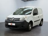 the small white van is parked in a large room