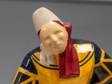 a figurine of a woman with a red scarf on her head