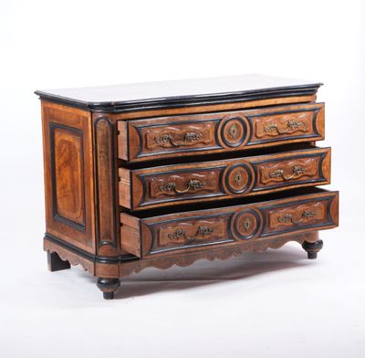 a small wooden chest of drawers with a marble top