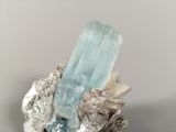 a piece of rock with a blue crystal on it