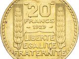a close up of a gold coin with a design on it